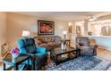 Cozy living room features hardwood floors, comfortable furniture, and warm neutral paint colors at 13961 E Marina Dr # 414, Aurora, CO 80014