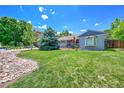 Expansive front yard featuring a mature tree, green lawn, and inviting curb appeal at 3313 S Dexter St, Denver, CO 80222