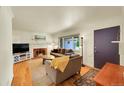 Cozy living room with fireplace, hardwood floors, and comfortable seating at 3313 S Dexter St, Denver, CO 80222