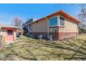 Spacious backyard featuring green grass, privacy fence, and a detached garage at 2301 Vine St, Denver, CO 80205
