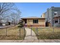 Quaint home with a fenced yard and charming walkway leading to the front entrance at 2301 Vine St, Denver, CO 80205