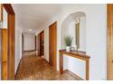 Inviting hallway with wood floors and a decorative console table with decor at 2301 Vine St, Denver, CO 80205