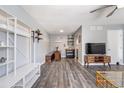 Spacious living room with modern shelving, gray walls, and lots of natural light at 1135 S Oneida St # F, Denver, CO 80224