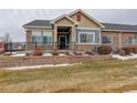 Tan and blue exterior of a ranch-style home with landscaping at 12444 Madison Way, Thornton, CO 80241