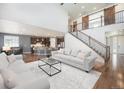 Open concept living room with a staircase and open layout to the kitchen at 8259 Arapahoe Peak St, Littleton, CO 80125