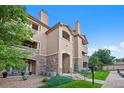Beautiful condominium complex featuring stone accents, balconies, and manicured landscaping at 9518 W San Juan Cir # 307, Littleton, CO 80128