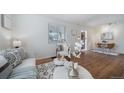 Bright living room showcasing hardwood floors and view into dining area at 7275 E 8Th Ave, Denver, CO 80220