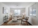 Cozy living room with hardwood floors, stylish decor, and ample natural light at 7275 E 8Th Ave, Denver, CO 80220