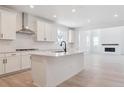 Modern kitchen with island and stainless steel appliances in an open floor plan at 8386 Cokedale Cir, Littleton, CO 80125