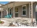 Close-up of a cozy front porch featuring stylish support beams and cheerful blue seating at 4353 Sherman St, Denver, CO 80216