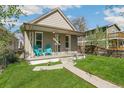 Inviting front porch with blue chairs and a decorative wreath, creating a warm welcome at 4353 Sherman St, Denver, CO 80216