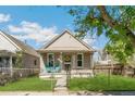 A quaint home with a neat front yard and a charming porch, perfect for relaxing outdoors at 4353 Sherman St, Denver, CO 80216