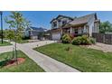 Lovely two-story home with a well-kept lawn and inviting front porch in a residential neighborhood at 16352 E 104Th Way, Commerce City, CO 80022