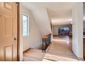 Inviting entryway featuring wood floors, staircase, and abundant natural light from a nearby window at 7476 E Arkansas Ave # 35-10, Denver, CO 80231