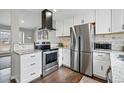 Bright kitchen with stainless steel appliances, white cabinets, and granite countertops and tile backsplash at 19820 E Amherst Dr, Aurora, CO 80013