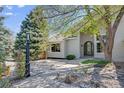 Beautiful entrance with a stone path leading to an arched front door and decorative rock landscaping at 6054 S Akron Way, Greenwood Village, CO 80111