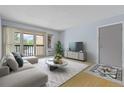 Bright living room featuring a sliding glass doors, neutral decor, and a stylish area rug at 850 W Moorhead Cir # 3L, Boulder, CO 80305