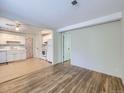 Bright living room with hardwood floors seamlessly connects to a classic white kitchen at 6047 S Hill St, Littleton, CO 80120