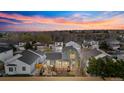 Aerial view of a well-maintained backyard with a wooden deck and mature landscaping in a residential neighborhood at 11825 Meadowood Ln, Parker, CO 80138