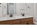 Modern bathroom featuring double sinks, sleek fixtures, and wood cabinets at 4729 Twelve Oaks Way, Castle Rock, CO 80104