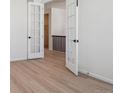 Bright bedroom with wood-look flooring, open french doors and neutral decor at 4729 Twelve Oaks Way, Castle Rock, CO 80104
