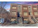 Attractive brick townhouse with a welcoming entrance, complemented by well-kept landscaping at 2311 Decatur St, Denver, CO 80211