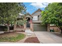 Charming two-story home with landscaped yard and covered porch at 11681 Night Heron Dr, Parker, CO 80134