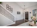 Bright foyer features hardwood floors, staircase, and modern decor at 11681 Night Heron Dr, Parker, CO 80134