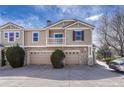 Charming townhouse with stone accents, a balcony, and attached garages at 12833 Mayfair Way # F, Englewood, CO 80112