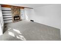 Bright living room featuring a stone fireplace and neutral carpet at 2639 S Xanadu Way # B, Aurora, CO 80014