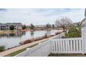 Picturesque water view overlooking a tranquil lake from behind a white fence at 15555 E 40Th Ave # 30, Denver, CO 80239