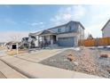 Attractive two-story home with stone accents, a well-kept front yard, and a two-car attached garage at 6506 Merrimack Dr, Castle Pines, CO 80108