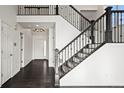 Elegant staircase with dark metal railing and dark hardwood floors at 388 English Sparrow Trl, Highlands Ranch, CO 80129