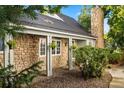 Charming stone exterior with covered porch and hanging plants, providing a welcoming entrance at 4505 S Yosemite St # 125, Denver, CO 80237