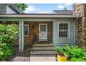 Charming front porch with stone accents, a decorative security door, and well-maintained landscaping at 4505 S Yosemite St # 125, Denver, CO 80237