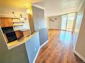 Bright living room featuring hardwood floors and a sliding glass door leading to a balcony with great natural light at 601 W 11Th Ave # 318, Denver, CO 80204