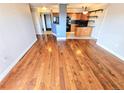 Spacious living room with hardwood floors, and an adjacent modern kitchen area with updated finishes at 601 W 11Th Ave # 318, Denver, CO 80204