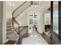 Grand curved staircase with ornate railing leading to upper level at 2198 Avenida Del Sol, Castle Rock, CO 80104