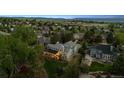 Expansive aerial view of a home with a well-manicured backyard featuring a covered patio and lush landscaping at 2187 Wynterbrook Dr, Highlands Ranch, CO 80126