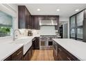 Modern kitchen featuring wooden cabinets, stainless steel appliances, and bright countertops at 2187 Wynterbrook Dr, Highlands Ranch, CO 80126