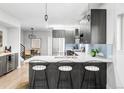 Modern kitchen features a sleek island with barstool seating and stainless steel appliances at 2435 S High St, Denver, CO 80210