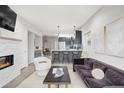 Open-concept living space with modern fireplace, seamlessly connecting to the kitchen at 2435 S High St, Denver, CO 80210