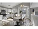 Modern kitchen with white cabinets, granite counters, and stainless steel appliances at 5462 S Valdai Way, Aurora, CO 80015