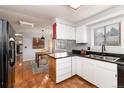 Eat-in kitchen with white cabinets and granite countertops at 401 S Dover Ct, Lakewood, CO 80226