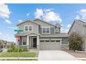 A charming two-story home boasting a covered porch, a two-car garage, and well-maintained landscaping at 12940 Brier Ct, Firestone, CO 80504