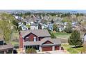 Aerial view of a two-story home in a suburban neighborhood with mountain views at 20670 Bridlewood Ln, Parker, CO 80138