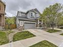 Two-story house with gray siding, stone accents, and a two-car garage at 10468 Wagon Box Cir, Highlands Ranch, CO 80130
