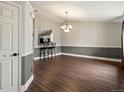 Elegant dining room with hardwood floors, modern lighting, and a convenient pass-through to the kitchen at 5204 S Parfet Way, Littleton, CO 80127