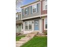 Two story townhome featuring decorative blue shutters and front door at 9632 W Cornell Pl, Lakewood, CO 80227