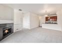 Bright living room featuring a fireplace, neutral carpet and an open layout to the kitchen at 4100 Albion St # 617, Denver, CO 80216